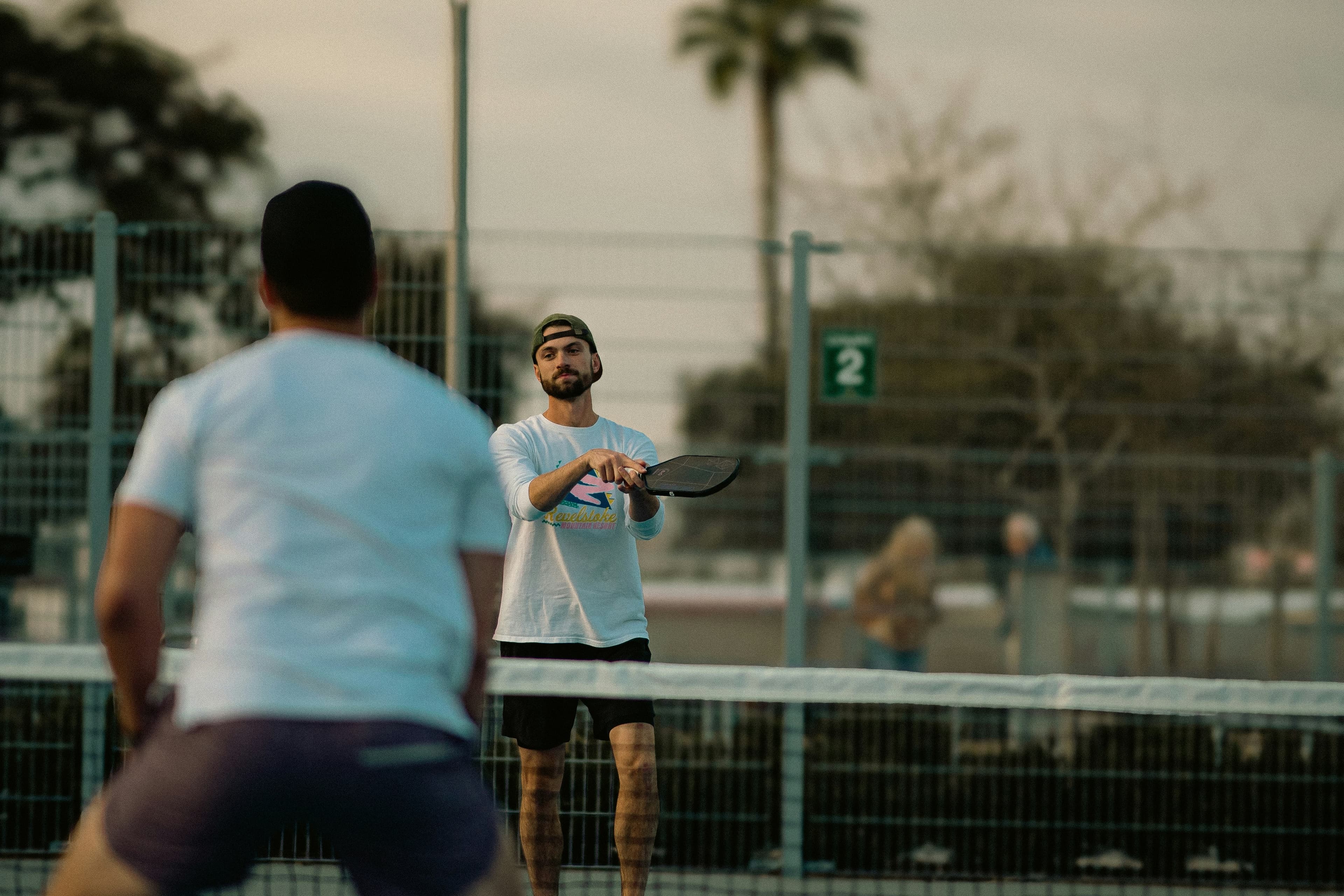 Two men playing tennis on a tennis court